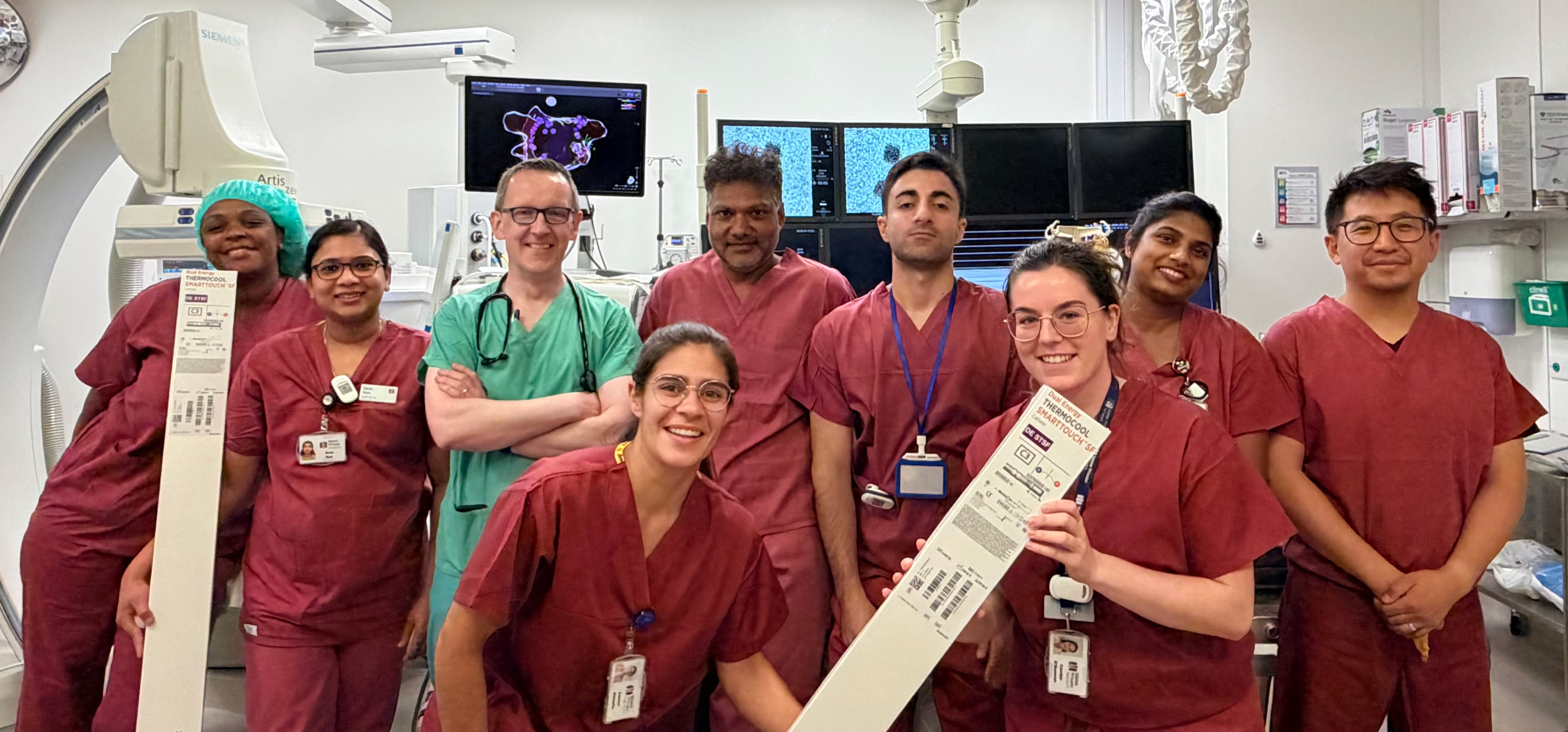 The team involved in the dual-energy ablation procedure posing in a group inside the catheterisation lab.