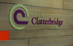 Clatterbridge Clinic logo on a wooden panel inside the clinic.