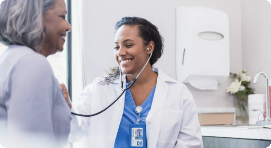 image A female medical professional is using a stethoscope to listen to a female patient's chest.