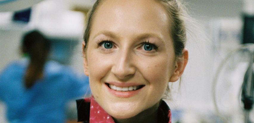 A blonde woman smiling at the camera