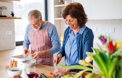 A married couple cooking together.