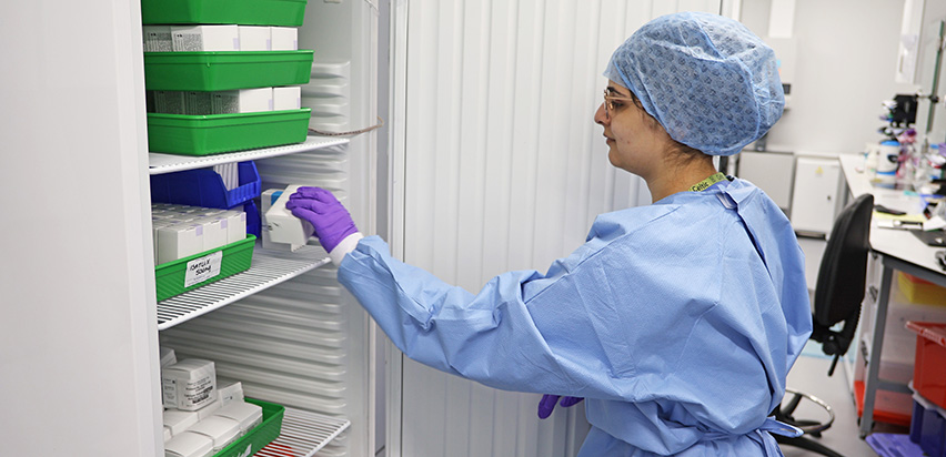 Mahreen Khosa is reaching into a fridge and picking up a box of medication
