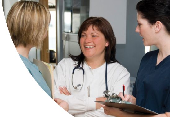 A group of female medical professionals chatting.