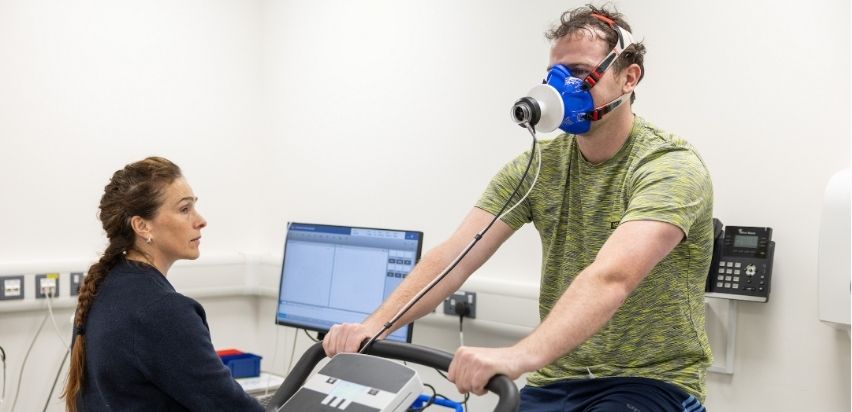 Male patient performing a VO2 Max test on a bike