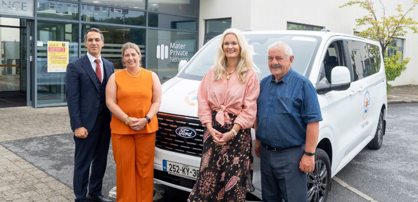 Kerry Cancer Bus 2 Dr. Mazen El Bassiouni, Dr. Lorraine Walshe, Lisa Cummins, and Sean Lyons standing beside the Kerry Cancer Bus in front of the Mid-Western Radiation Oncology Centre in Limerick.