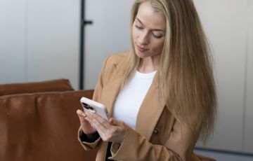 Woman checking her phone on a waiting room
